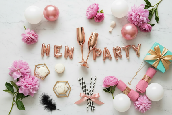 create a flat lay for Hen Party celebration. Make it fun and festive but not vulgar. Color palette: stronger lively rose pink, white, black, turquoise and gold. Light marble background with no visible shadows, shadowless.